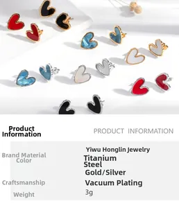 Detailed macro view of heart-shaped titanium steel earrings with enamel oil painting finish
