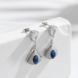 Elegant silver fan-shaped earrings with blue oval gemstone and pear-cut zircon accents