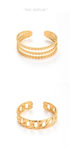 Dettaglio di bracciali in acciaio inossidabile dorato con motivi a perline e catena