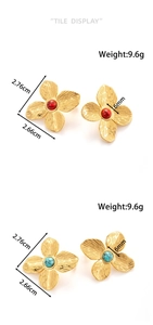 Detail view of floral earrings showing brushed gold petals and colorful gemstone centers