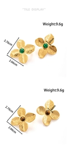 Close-up of flower earrings with gold finish and green malachite or tiger eye centers