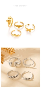 Nahaufnahme der polierten Edelstahl-Ringe mit Herz und Schleife in Gold und Silber-Set