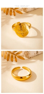 Detail of adjustable gold ring featuring a minimalist smiley face engraving on a round disc