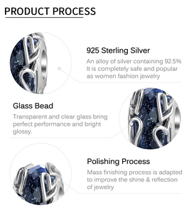 Detailed macro view of S925 sterling silver heart charm with faceted deep blue glass bead