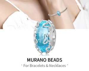 Macro shot of blue Murano glass charm with silver butterfly overlay and S925 hallmark