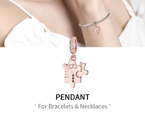 Detail of rose gold jigsaw puzzle pendant with tuxedo enamel and shimmering zircons