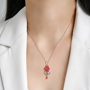 Detail of S925 sterling silver floral pendant with red enamel and multi-color gemstones