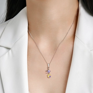 Elegant S925 sterling silver butterfly and purple flower pendant necklace on white suit