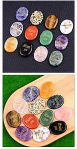 Macro detail of polished natural crystal stones with golden Missing You engraving