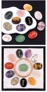Macro view of polished energy stones set with engraved golden Buddhist mantras