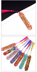 Detail view of seven chakra resin bookmarks with natural crystals and colorful tassels