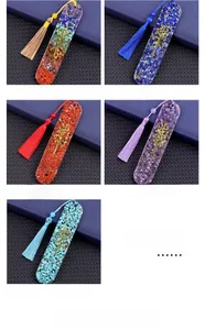 Detail view of oval resin bookmarks with Tree of Life charms and colorful gemstone chips