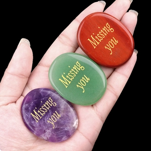 Polished natural crystal stones set with gold engraved Missing You text in hand