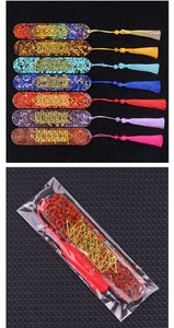 Detail of resin bookmarks with natural crystal chips, gold accents and silk tassels