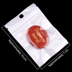 Polished red jasper palm stone engraved with Discover your inner self in gold lettering