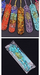Macro view of oval resin bookmarks with tree of life charms and colorful crystal stones