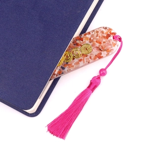Oval crystal resin bookmark with orange gravel, chakra symbols, and pink tassel detail