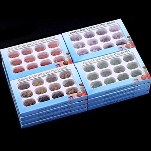 Set of 12 hand-carved natural crystal elephant figurines in a window display box