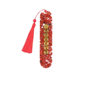 Oval resin bookmark with natural chakra healing crystals and a decorative red tassel