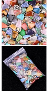 Detailed view of assorted natural crystal trapezoid pendants with silver metal clasps