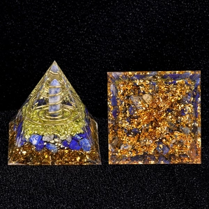 Lapis Lazuli Orgone Pyramid with blue crystal and gold coil on dark background