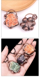Detail of vintage wire-wrapped natural crystal pendants with intricate copper craftsmanship
