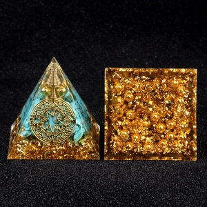 Handcrafted orgonite pyramid with blue turquoise stones and golden galaxy symbols