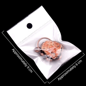 Vintage bronze pendant necklace with natural orange agate crystal in retail packaging