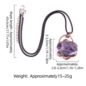 Vintage style raw amethyst necklace with copper trim and black braided cord on white background
