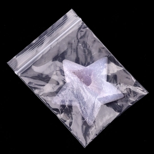 Handcrafted star-shaped purple agate druzy crystal stone carving on black background