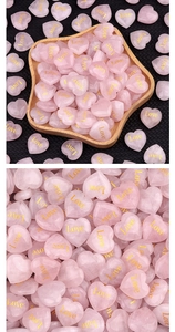 Macro detail of pink rose quartz heart stone with elegant gold Love engraving