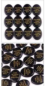 Close-up of polished black oval worry stones with gold engraved motivational text
