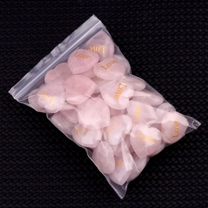 Pink heart-shaped rose quartz stones with gold Love engraving in clear packaging
