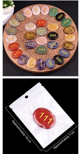 Macro detail of engraved angel numbers on polished natural crystal palm stones on wood tray