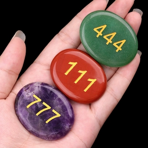 Polished natural crystal palm stones with engraved gold angel numbers for meditation