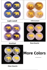 Detailed close-up of natural crystal stones with golden bear carvings in multiple colors