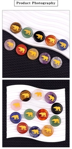 Macro detail of natural crystal stone discs featuring gold bear silhouette engravings
