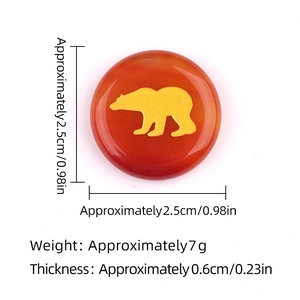 Natural red agate stone disc with golden bear engraving showing 2.5cm diameter size