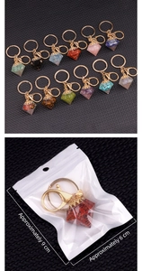 Macro detail of diamond-shaped crystal resin keychain charms with dimension indicators