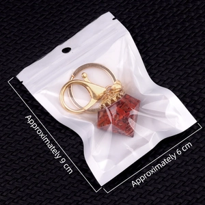 Natural red crystal stone resin pyramid keychain with golden metal clasp and packaging