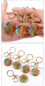 Detailed view of colorful Orgonite resin flower keychains with sacred spiritual symbols
