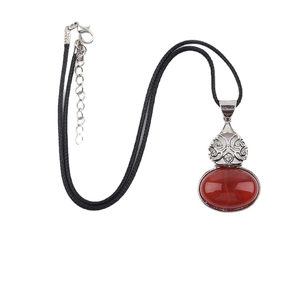 Vintage style red agate oval pendant with silver filigree on a black cord necklace
