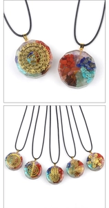 Détail d'un pendentif Orgonite avec cristaux naturels et symboles spirituels dorés