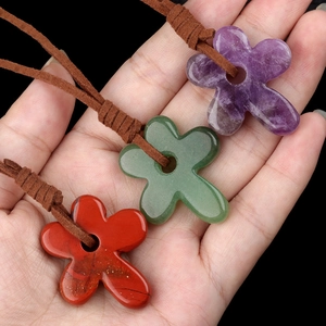 Set of three carved flower stone pendants in amethyst and jasper with leather cords