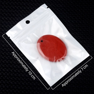 Polished oval red crystal stone pendant material in clear packaging bag with dimensions