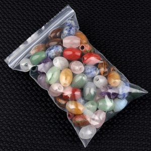 Mix of colorful barrel-shaped stone beads in a transparent zip bag for DIY jewelry