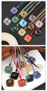 Detailed macro of 30mm square natural crystal agate pendants with woven cord necklaces
