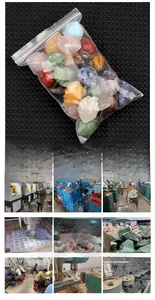 Detailed view of assorted colorful crystal heart carvings in bulk transparent packaging