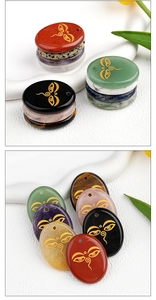 Macro view of crystal palm stones with golden Buddha eye engraving in varied natural colors