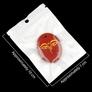 Natural red stone palm pendant with All Seeing Eye symbol in clear packaging